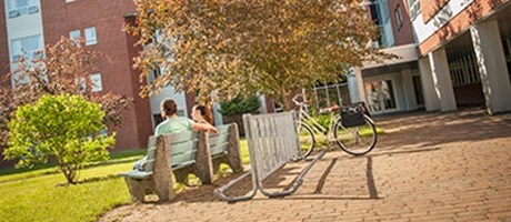 Students sitting on a bench outdoors at Bishops