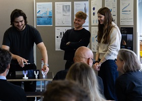 Students present and discuss oral care prototypes in front of a group