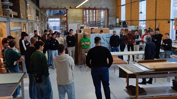 Group of students gathered for a discussion in a workshop environment