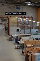 Assembly workshop with machines, workbenches and materials in an industrial workspace