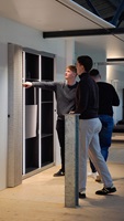 Students examine an illuminated furniture or interior design element in a studio