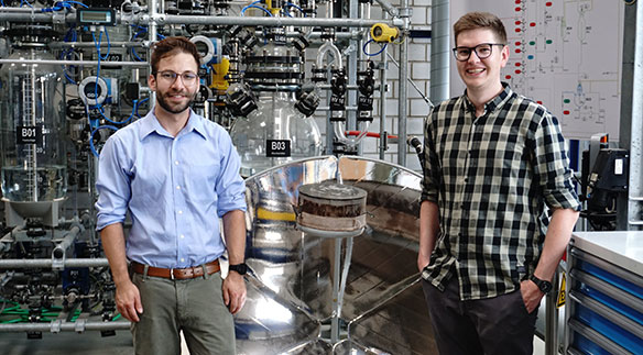 Die HSLU-Studenten Julian Zölly (links) und Patrick Estermann (rechts) vor dem Funktionsmodell ihres Solarkochers mit thermischem Energiespeicher.