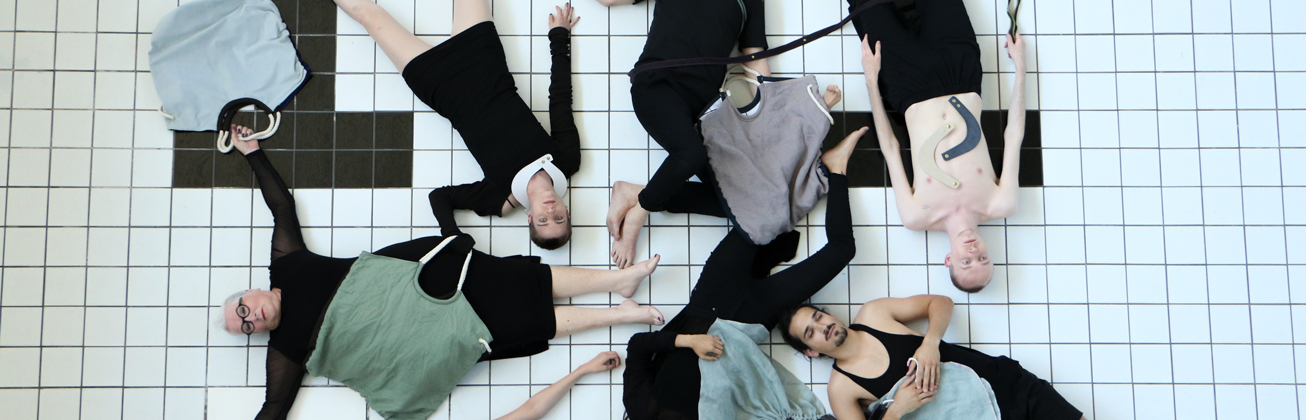 Leute liegen auf dem Rücken auf weissen Kacheln