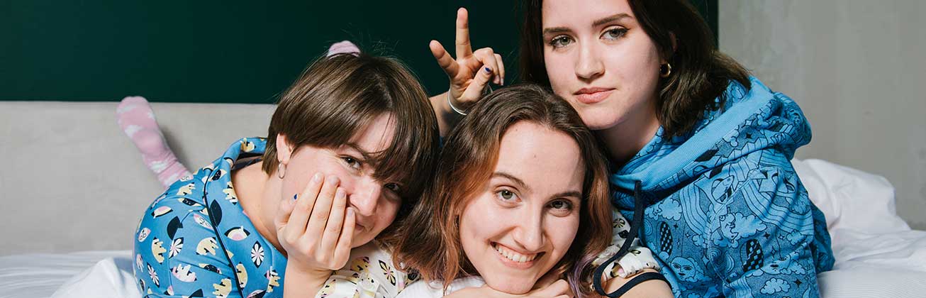 Drei Studentinnen tragen ihre selbst entworfenen Pyjamas