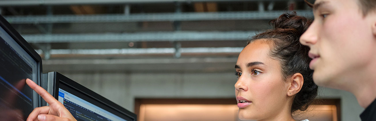 Two students work on a computer
