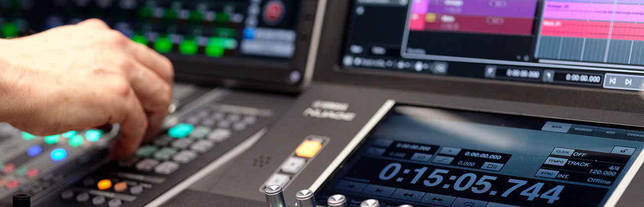 Hand am Mischpult im Regieraum der Hochschule Luzern – Musik.