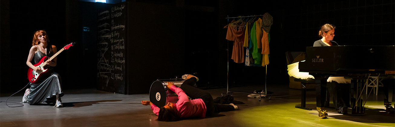 Drei Studierende in farbigem Rampenlicht während einer Performance am Diplomprojekt des Bachelors/Musik und Bewegung