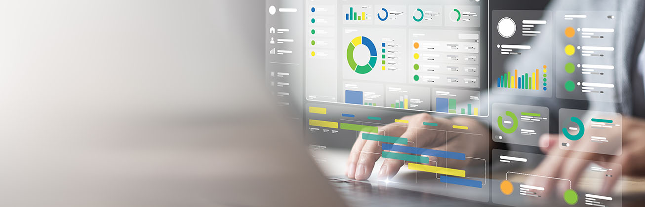 Person nutzt Laptop mit eingeblendeten Daten-Dashboards.