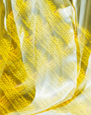 Ein gelb getsricktes Textil, das eine gewobene Textur hat