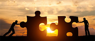 People who push puzzle pieces towards each other