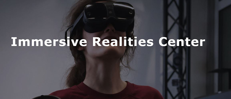Woman with VR glasses and lettering Immersive Realities Center