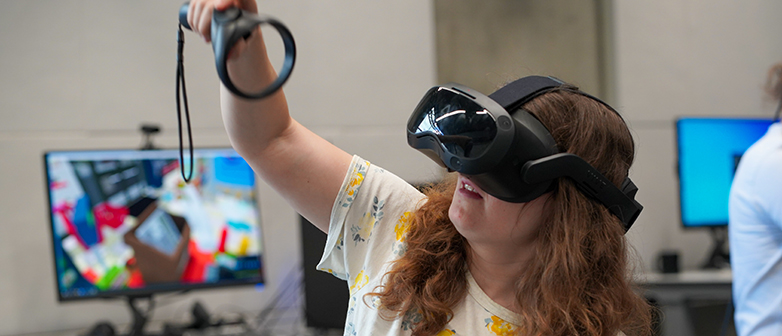 Girl experiments with VR goggles and controller