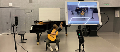 Junge sitzt und spielt Gitarre