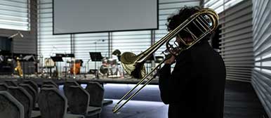 A trombonist practising in the concert hall. 