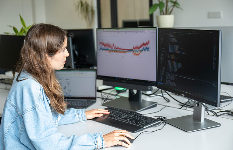 Female student programming algorithms on PC.