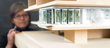 Researcher looks at a building model