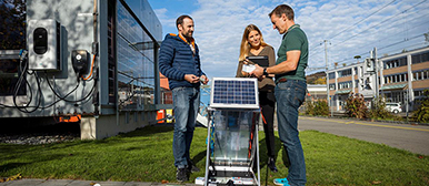 Three people on a solar panel