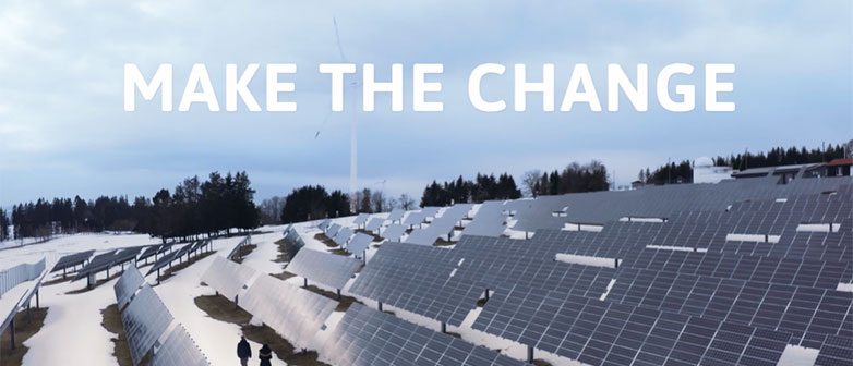 Solar farm in a snowy field with “MAKE THE CHANGE” text, symbolizing renewable energy and sustainability transition