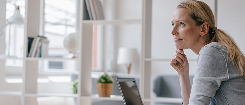 Frau sieht nachdenkend in die Ferne