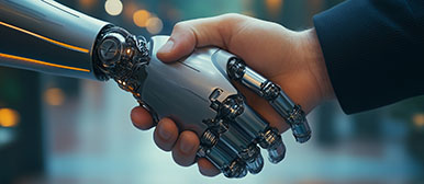Symbolbild für KI in der Praxis: Ein Mensch schüttelt die Hand eines humanoiden Roboters